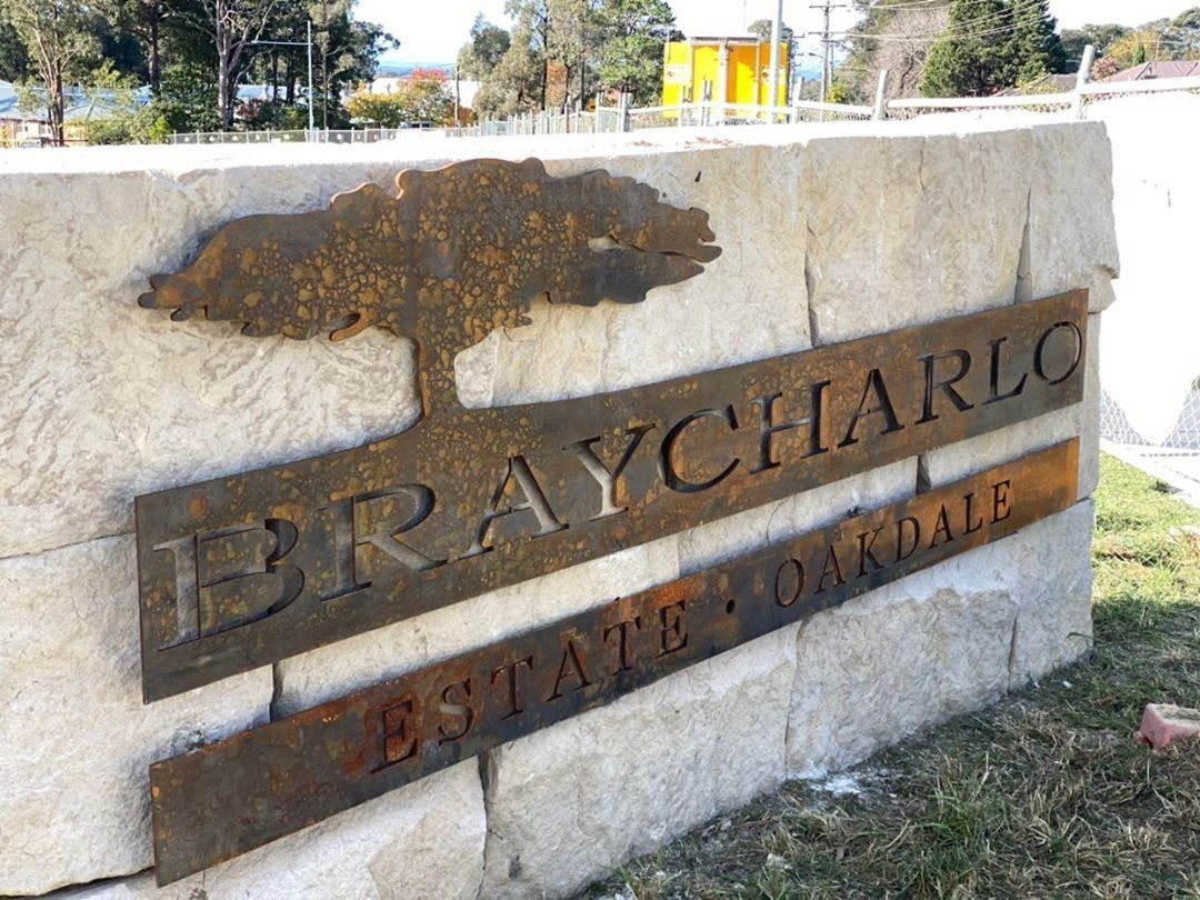 Braycharles State Park stone sign with metal lettering and a tree emblem