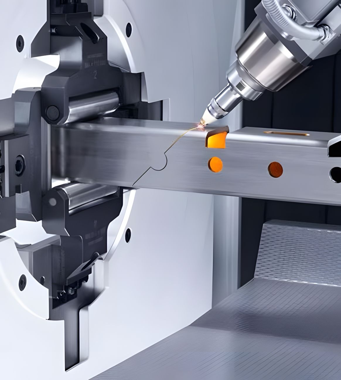 A machine is cutting a piece of metal on a table