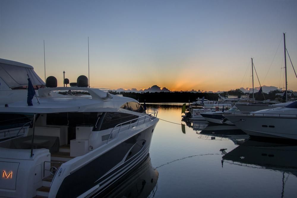 A Boat Is Docked In A Marina At Sunset — PASMA Electrical In Atherton, QLD