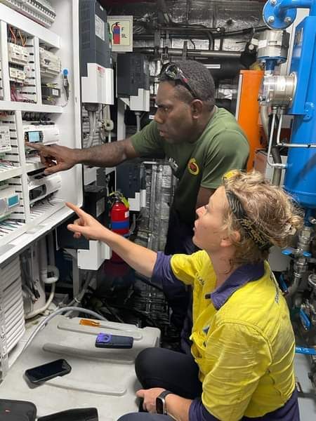 A Man And A Woman Are Working On A Machine — PASMA Electrical In Portsmith, QLD