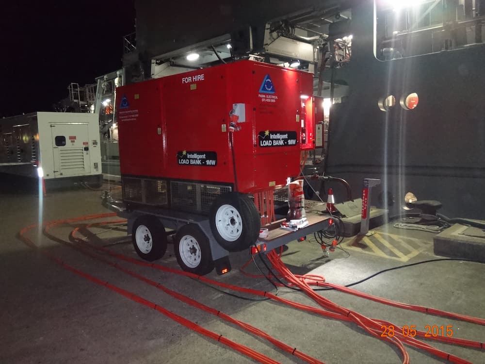 A Red Generator Is On A Trailer In A Parking Lot At Night — PASMA Electrical In Portsmith, QLD