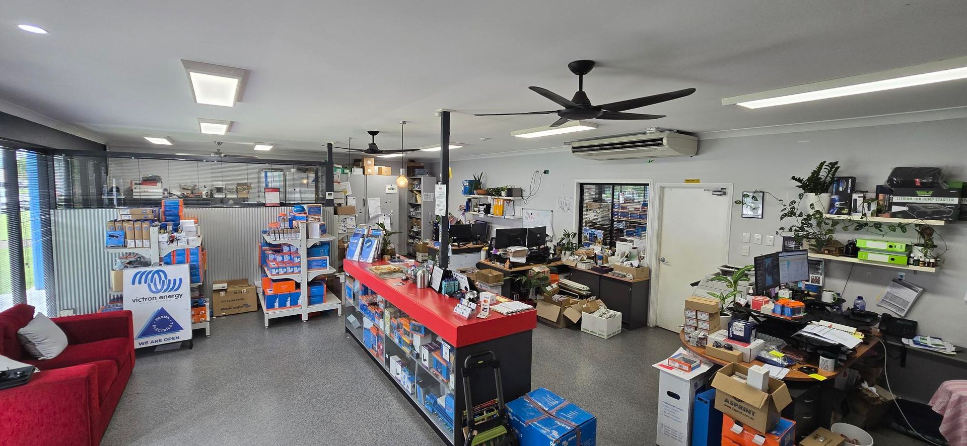 A Man Wearing Headphones Is Working On A Piece Of Equipment — PASMA Electrical In Portsmith, QLD