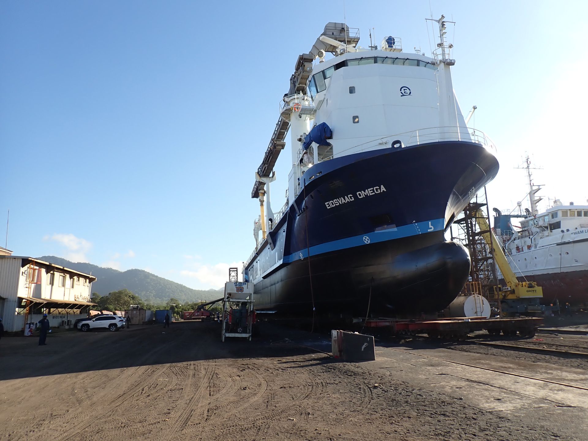 A Large Blue And White Ship Is Sitting In A Parking Lot — PASMA Electrical In Portsmith, QLD