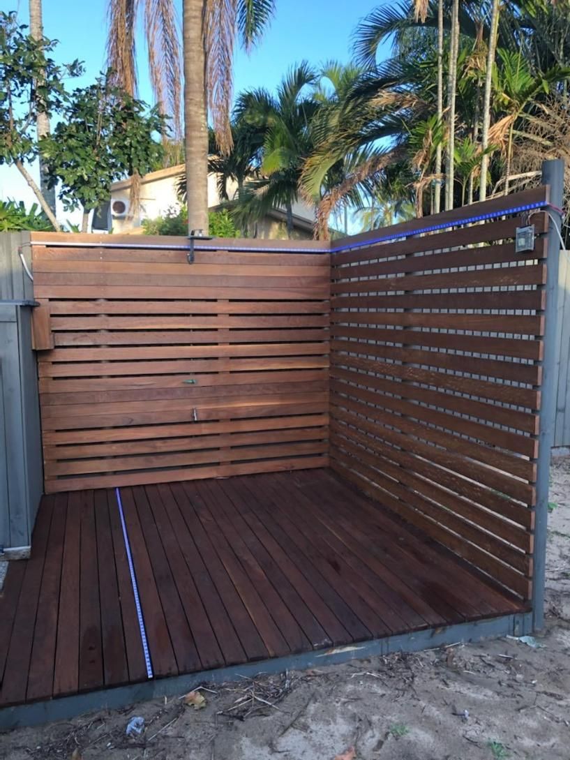 A Wooden Fence is Surrounding a Wooden Deck — Mackay Hardwood Sales in Cannonvale, QLD