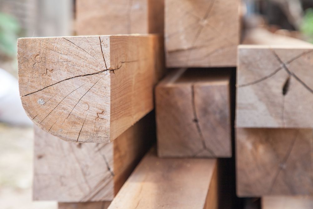 A Pile of Wooden Beams Stacked on Top of Each Other — Mackay Hardwood Sales in Cannonvale, QLD