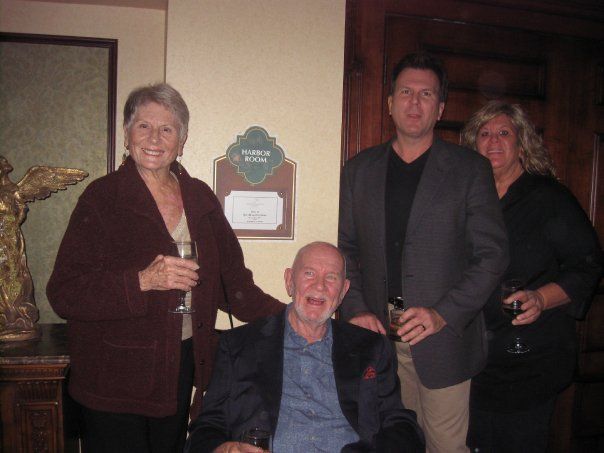 a group of people posing for a picture in front of a sign that says welcome