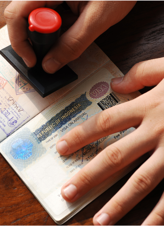 a person is stamping a visa on a passport