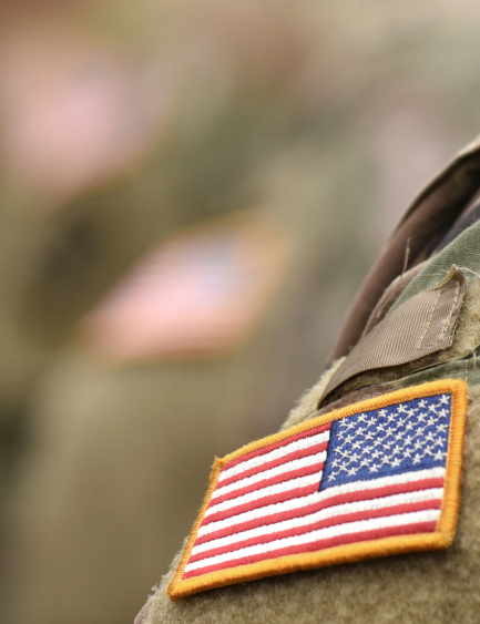 a close up of an american flag patch on a soldier 's uniform .