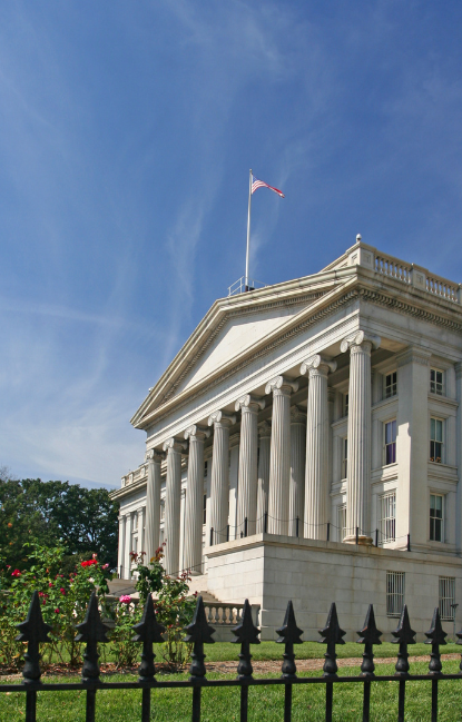 a large building with columns and a flag on top of it