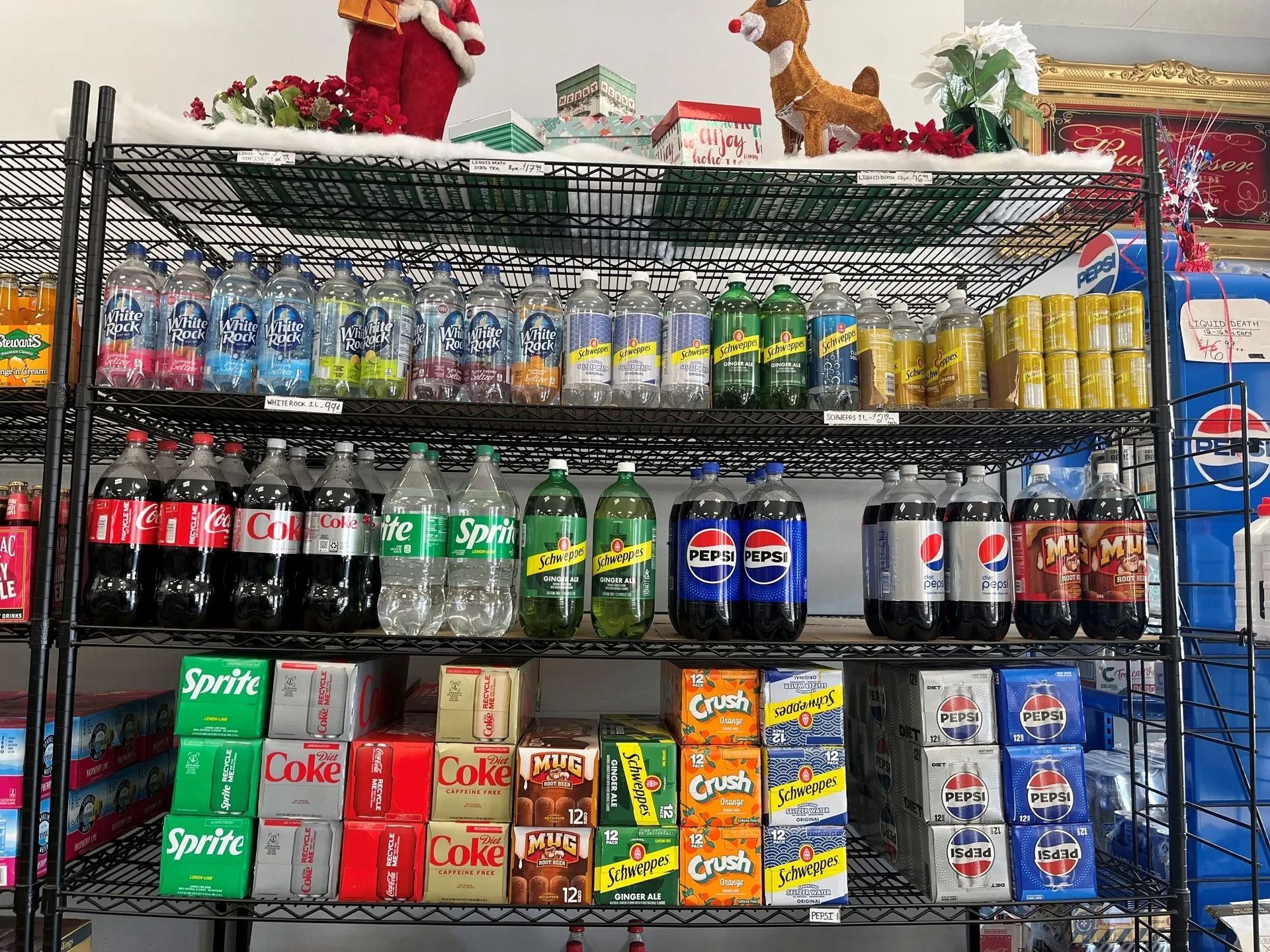 Shelves stocked with various sodas and holiday decorations.