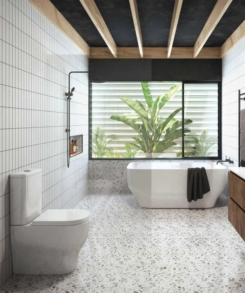A Bathroom With a Tub, Toilet, Sink and Window — Northern Tile Gallery in Winnellie, NT