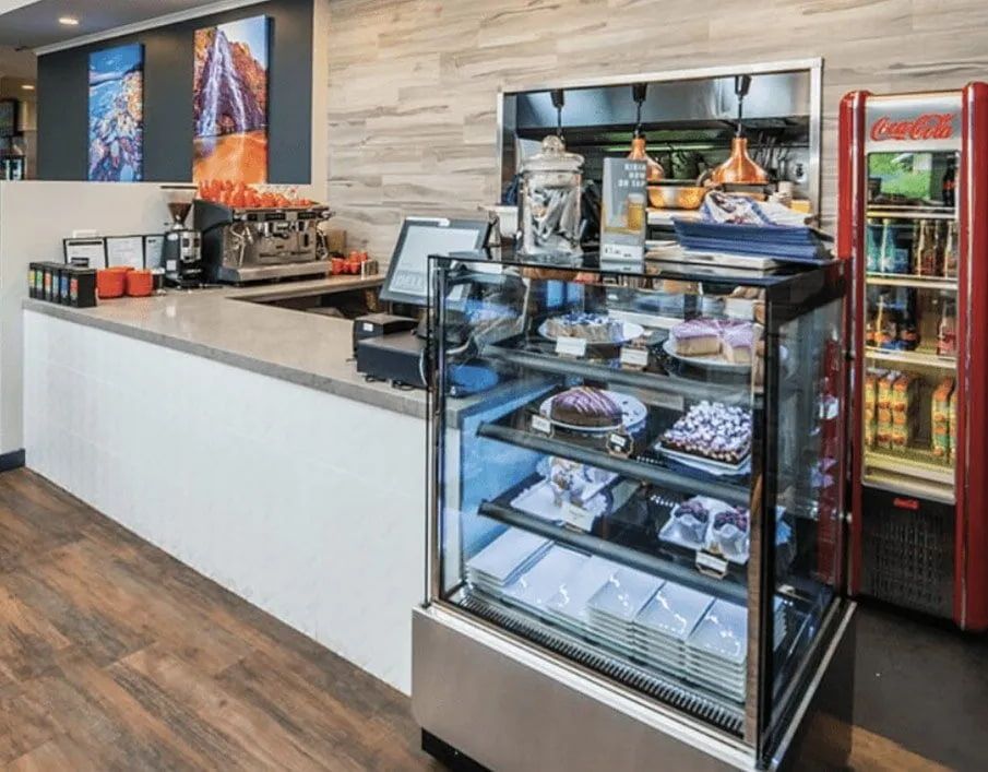 A Bakery With a Glass Display Case Filled With Cakes — Northern Tile Gallery in Winnellie, NT