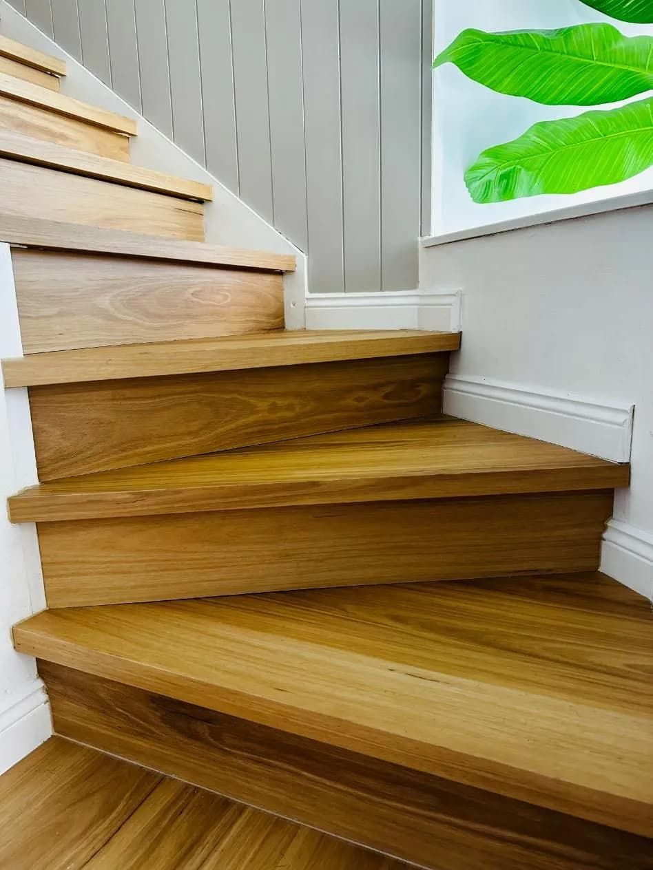 A Wooden Staircase With a Picture of a Plant on the Wall — Northern Tile Gallery in Winnellie, NT
