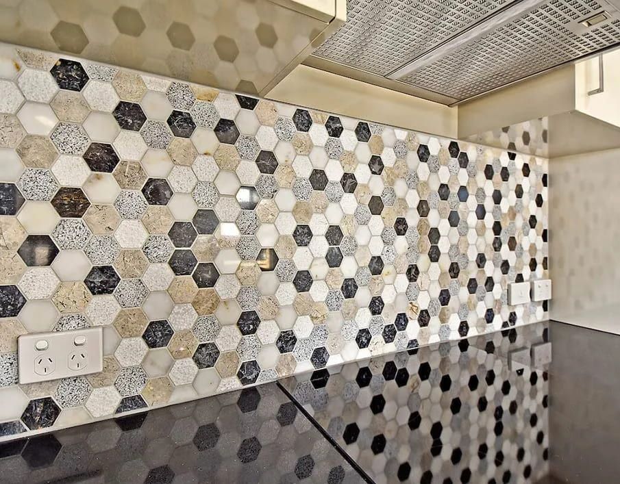 A Kitchen With Hexagonal Tiles and a Black Counter Top — Northern Tile Gallery in Winnellie, NT