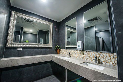 A Bathroom With Two Sinks and a Large Mirror — Northern Tile Gallery in Winnellie, NT