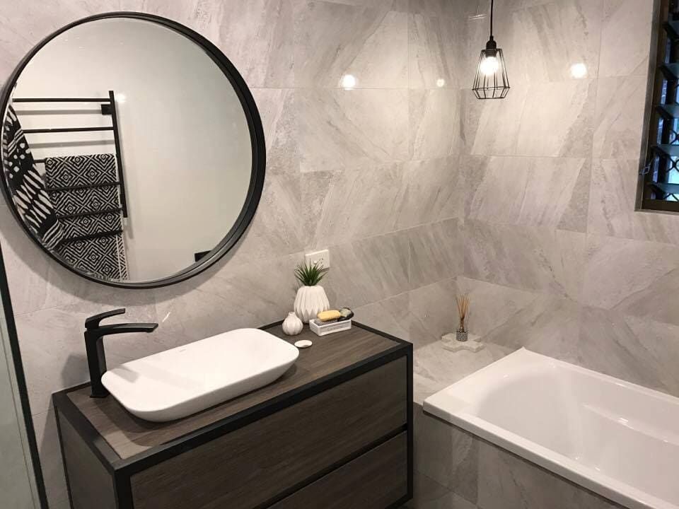 A Bathroom With a Sink, Mirror and Bathtub — Northern Tile Gallery in Winnellie, NT