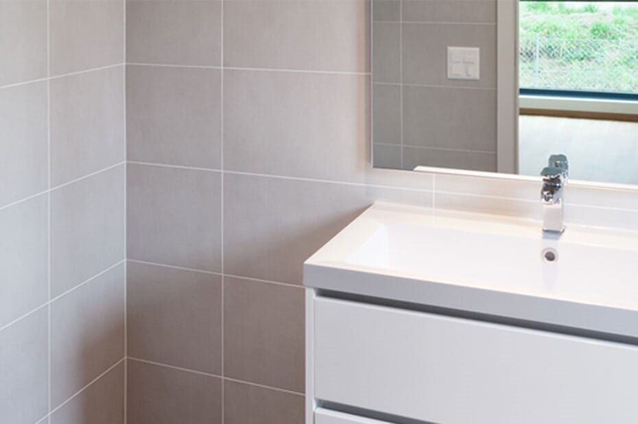 A Bathroom With a Sink, Mirror and Window — Northern Tile Gallery in Winnellie, NT