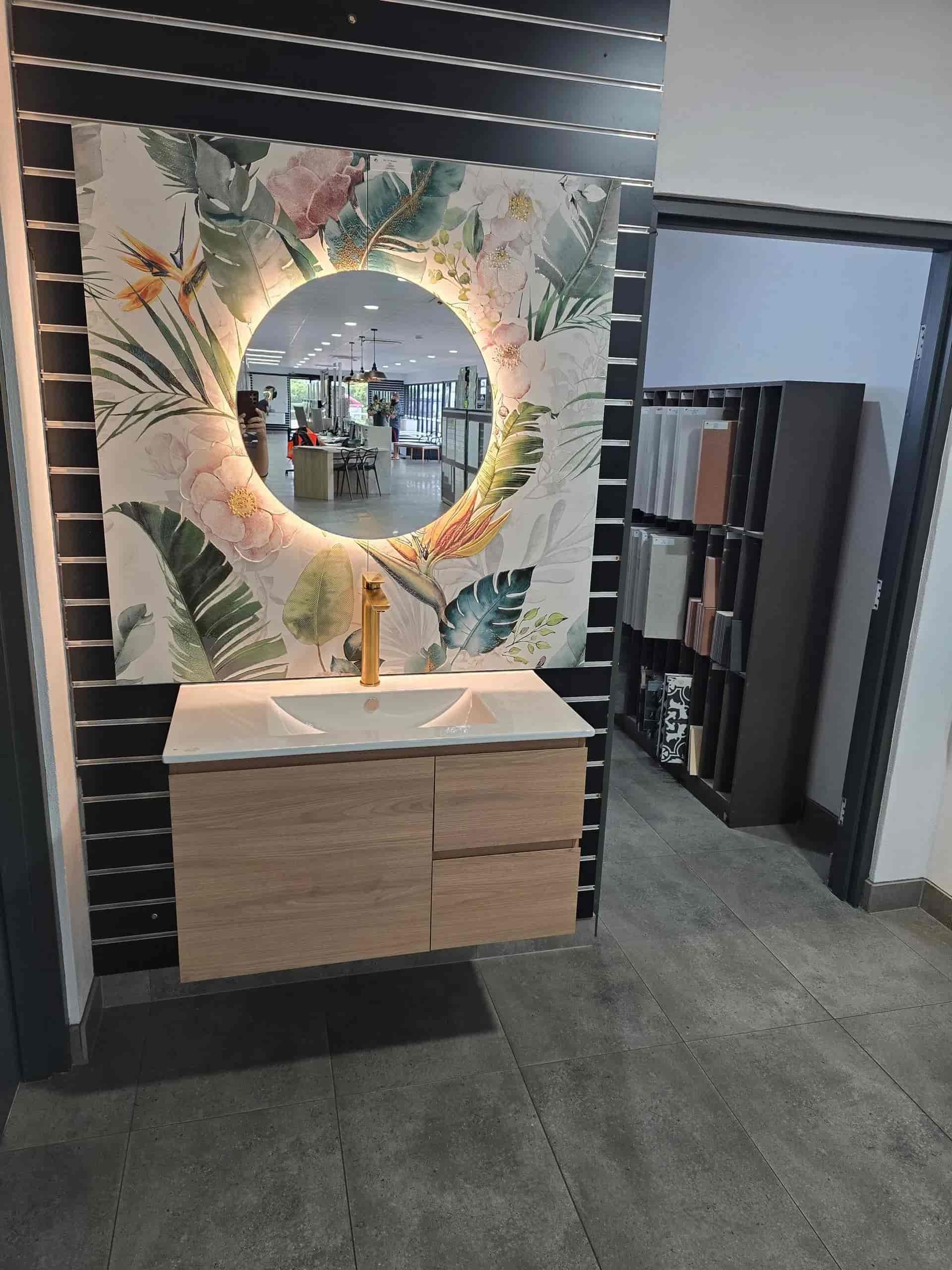 A Bathroom With a Sink and a Round Mirror — Northern Tile Gallery in Winnellie, NT