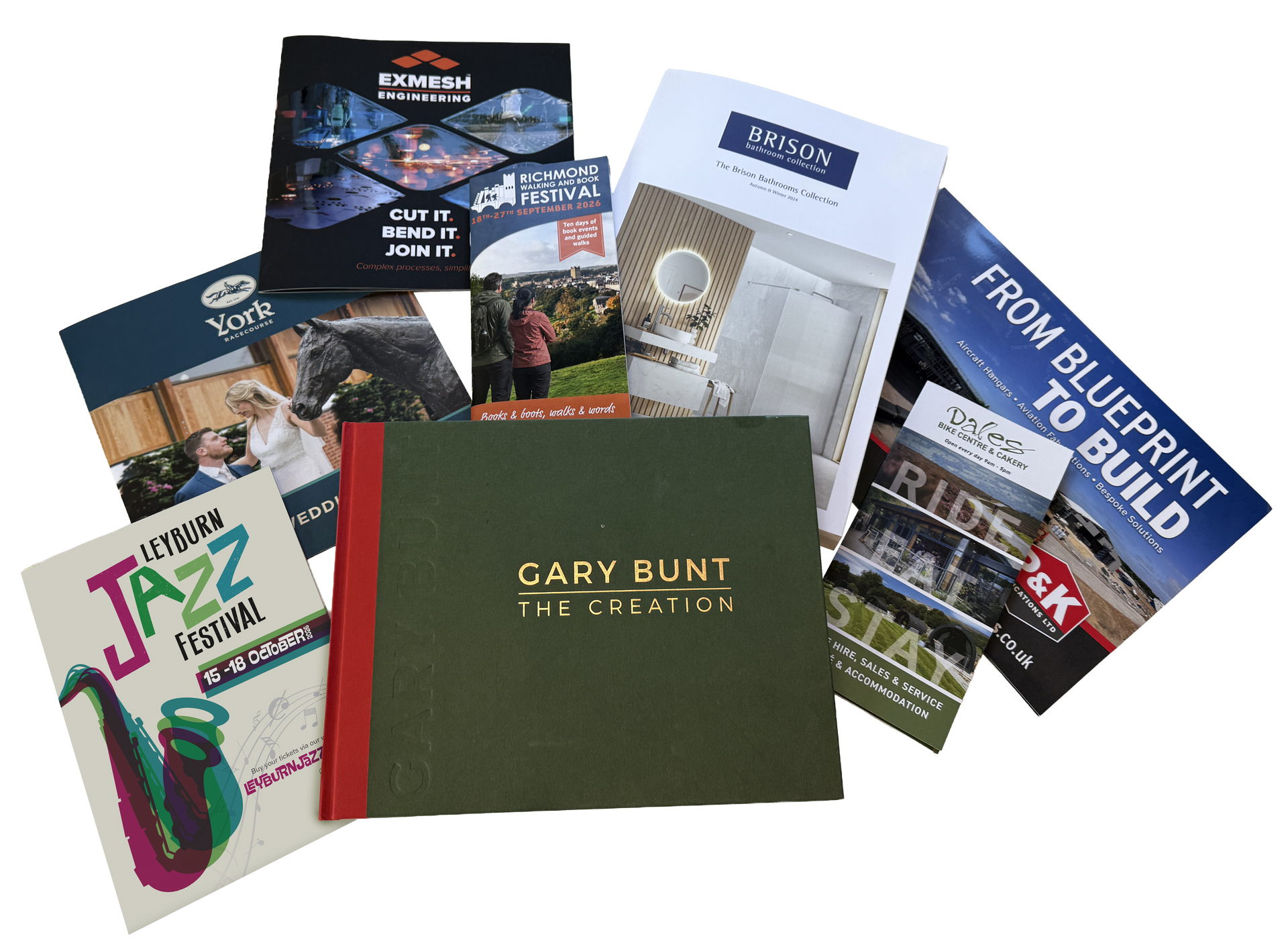 Assorted construction and architecture brochures and booklets fanned out on a white background