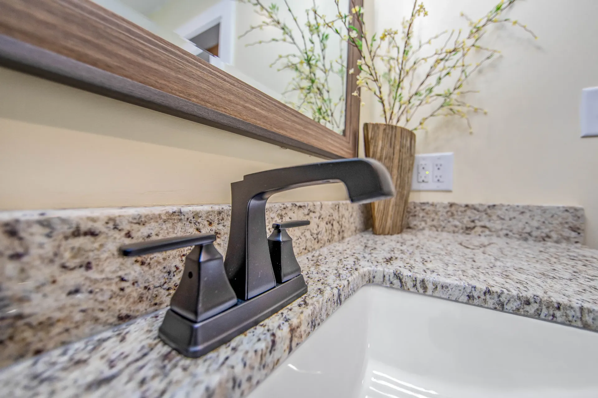 A bathroom sink with a faucet and a mirror.
