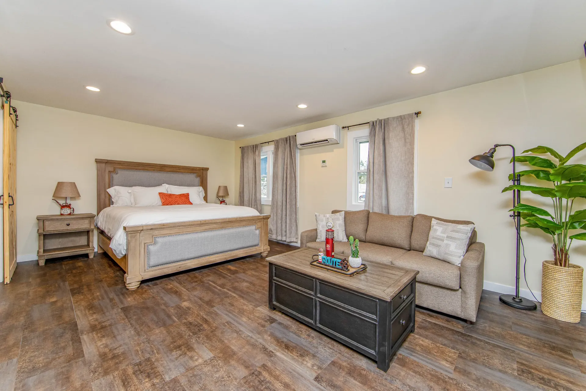 A bedroom with a king size bed , a couch , and a coffee table.