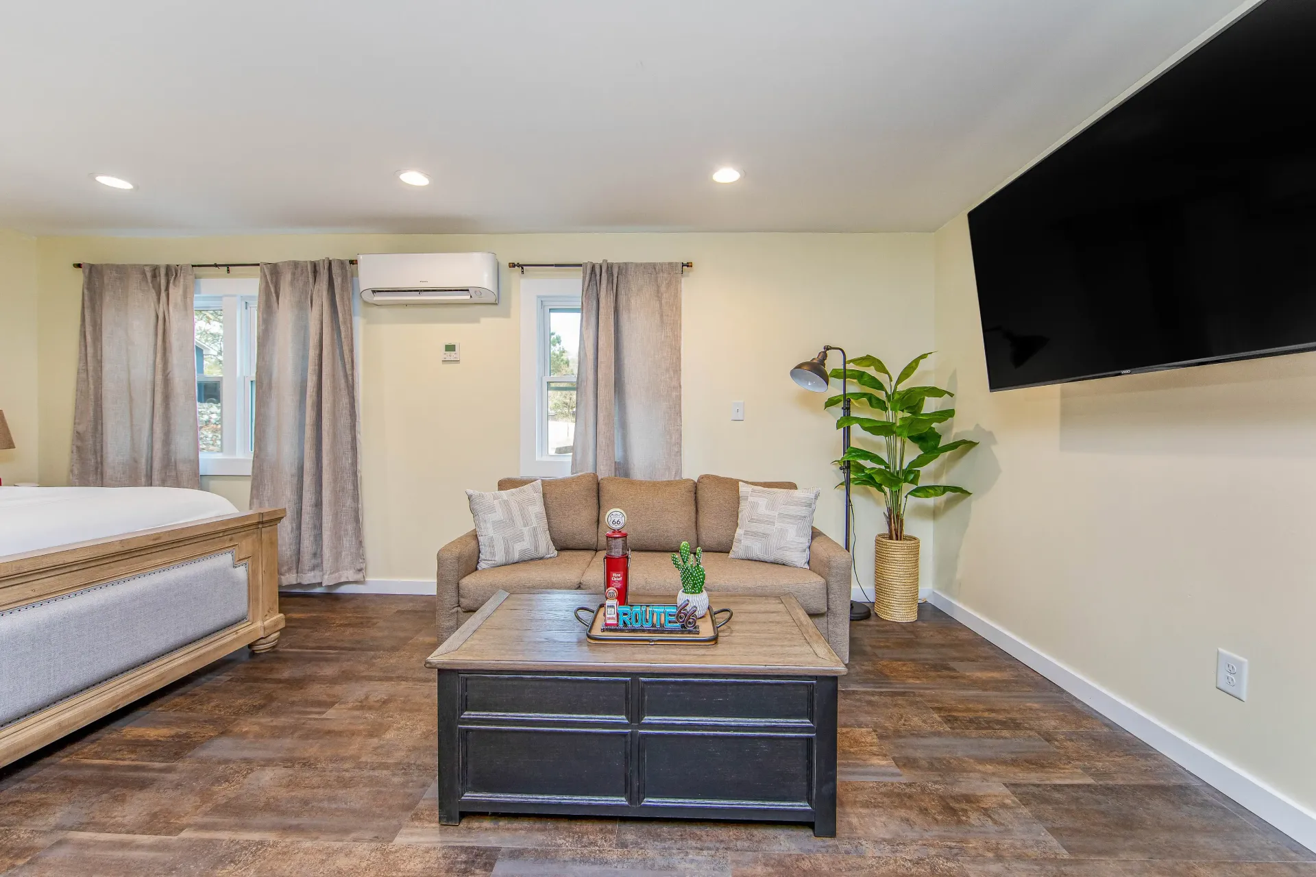 A living room with a couch , coffee table , and television.
