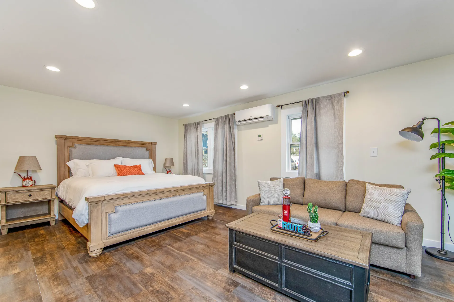 A bedroom with a king size bed , a couch , and a coffee table.