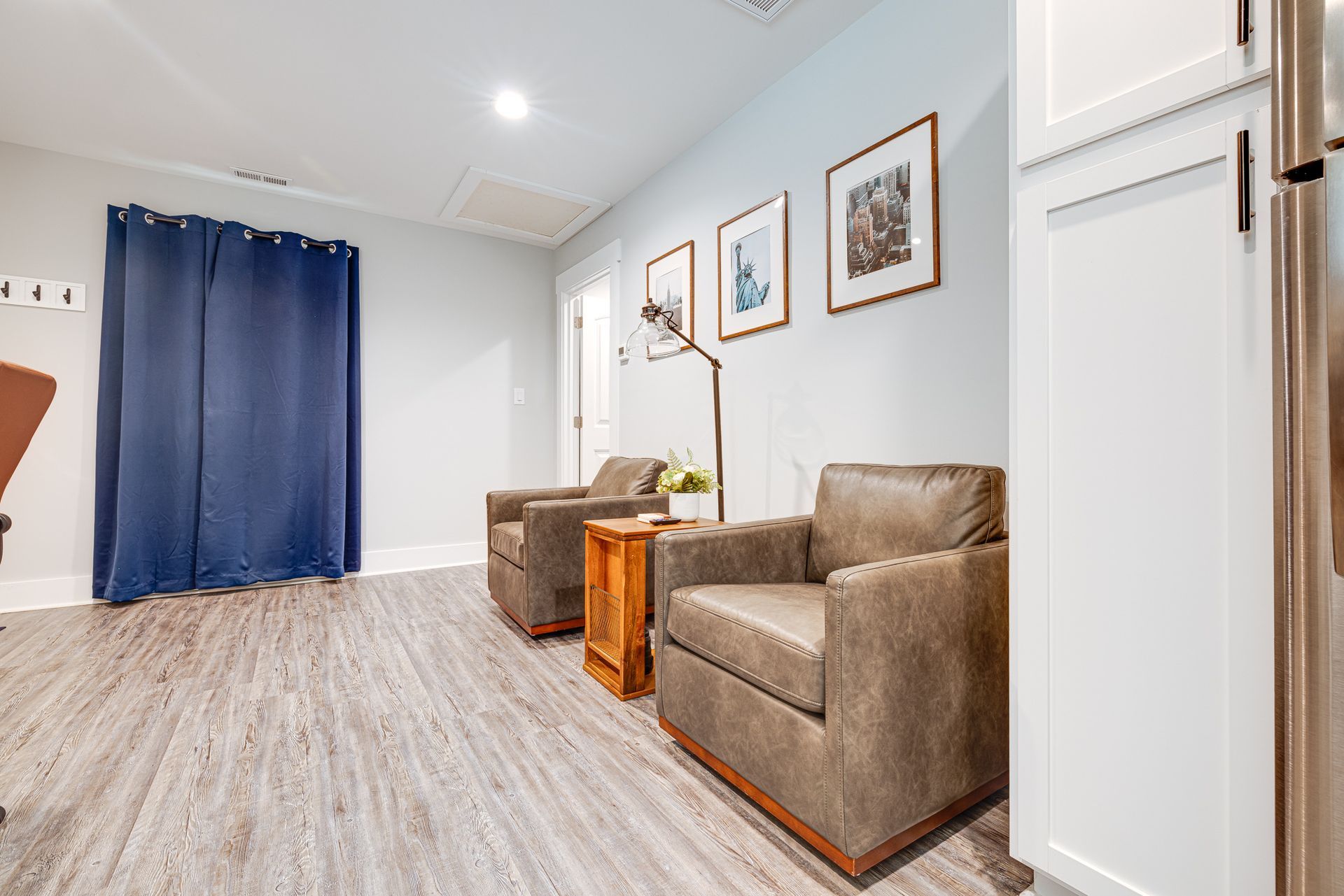 A living room with two chairs and a table.