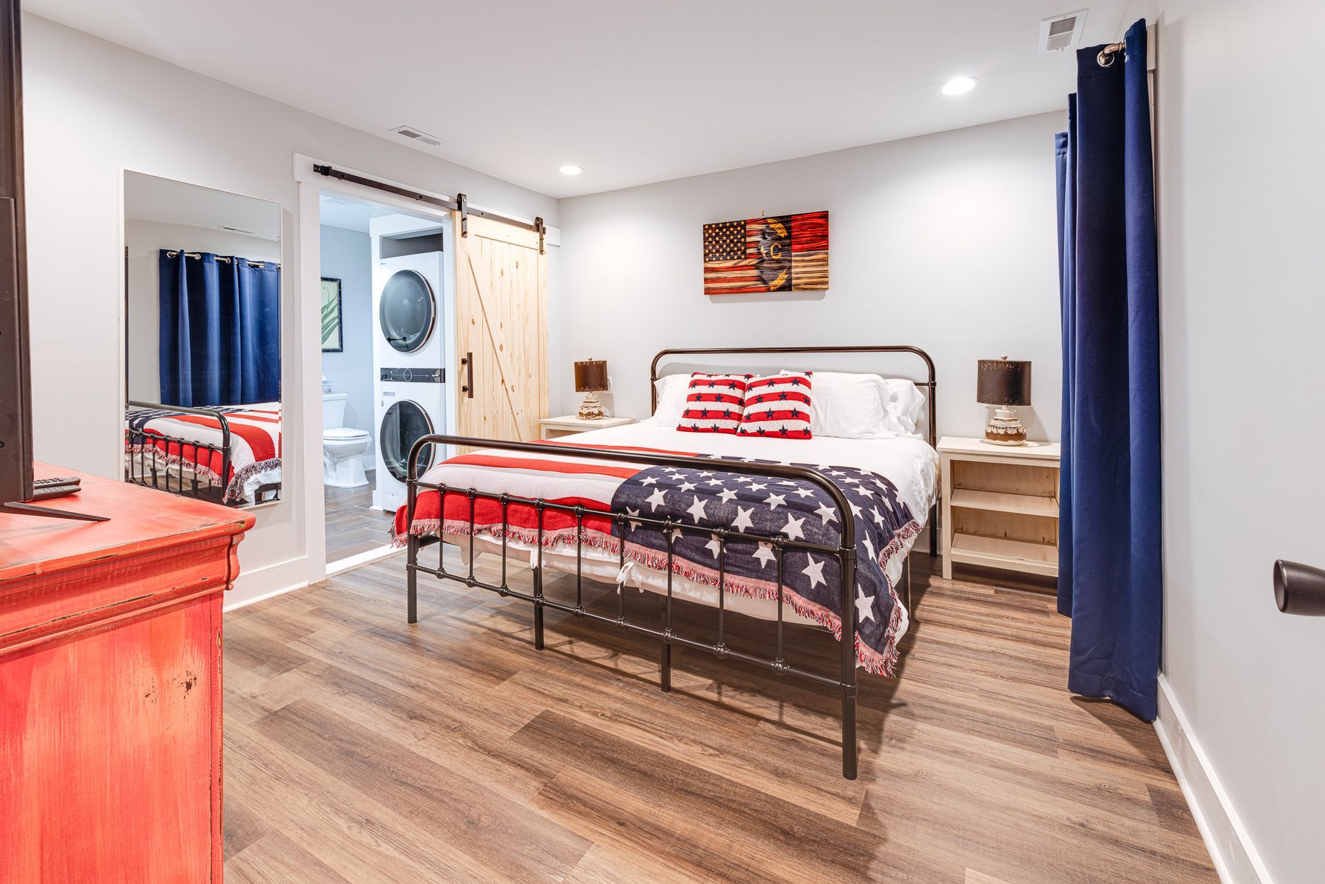 A bedroom with a bed , dresser , and television.