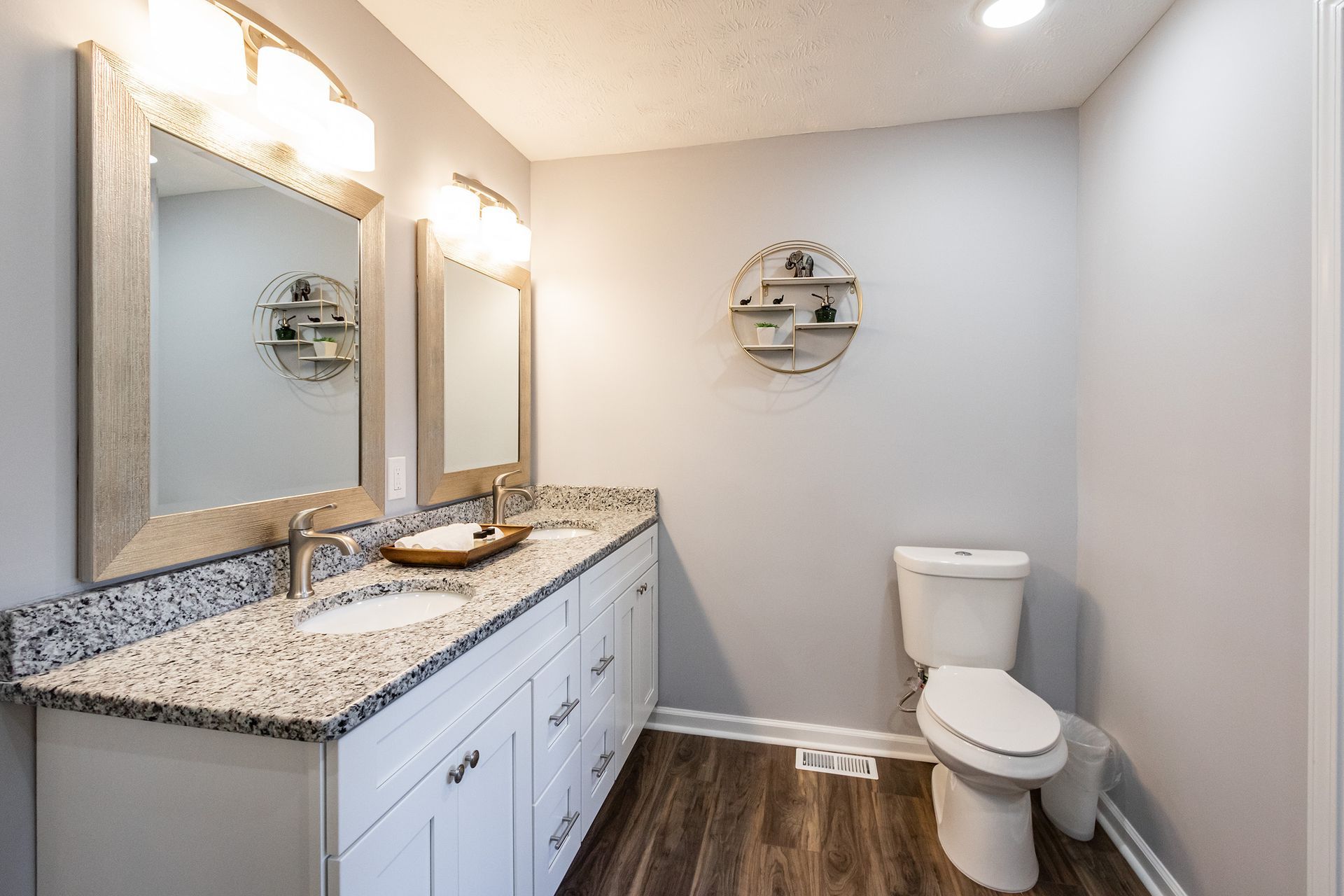 A bathroom with two sinks and a toilet.