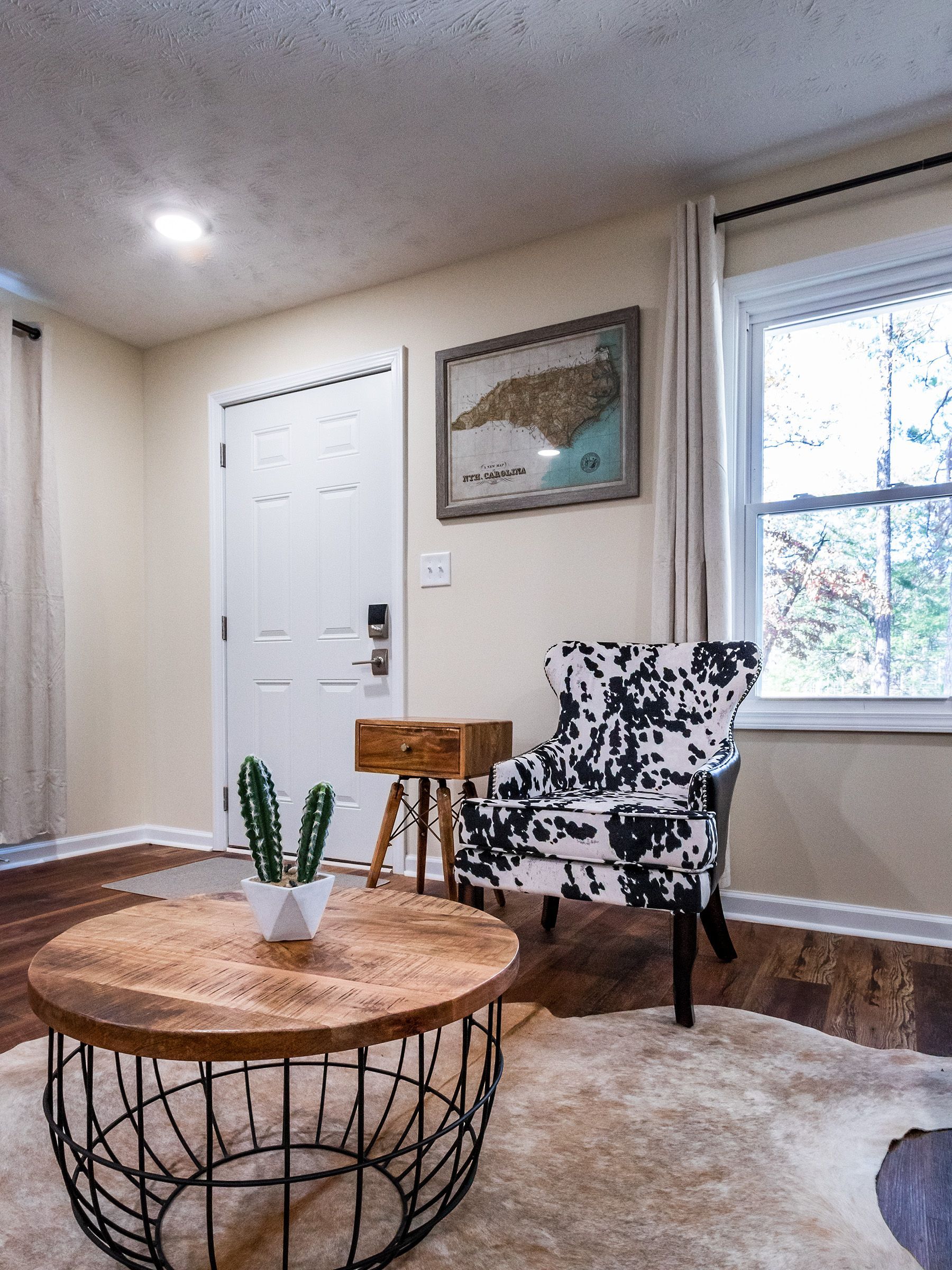 A living room with a round coffee table and a chair