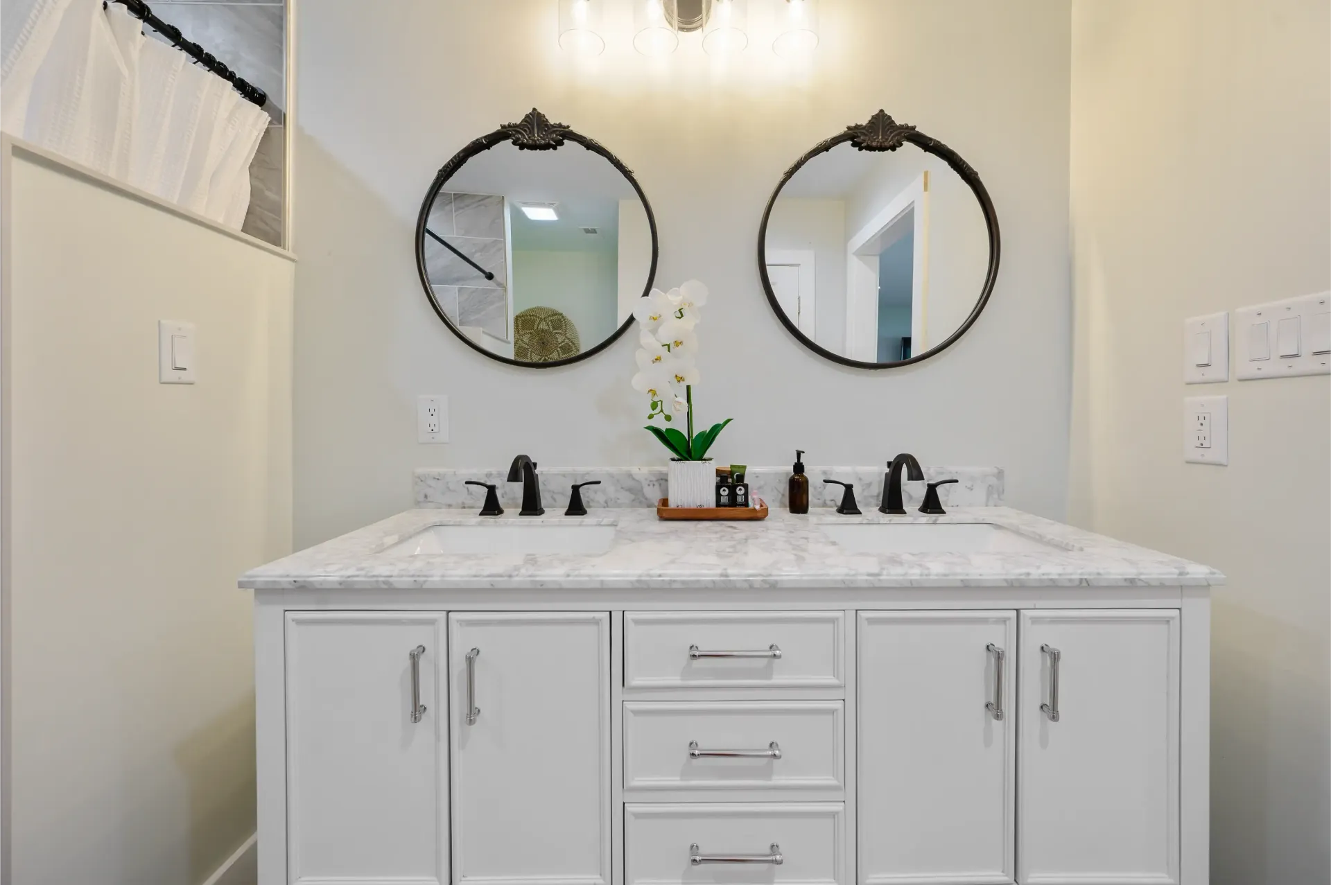 A bathroom with two sinks and two mirrors.