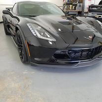 a black sports car is parked in a garage .