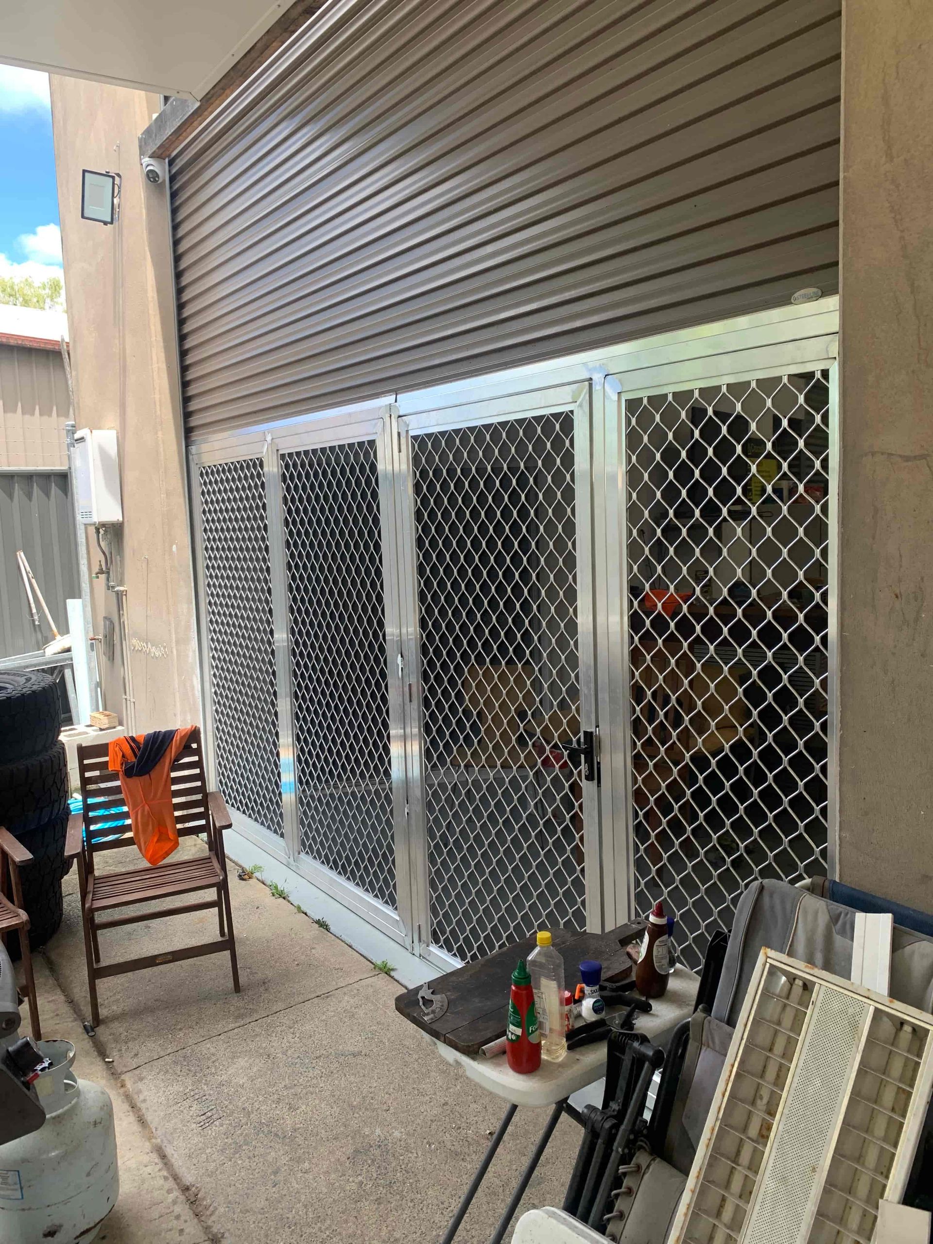 A patio with a table and chairs and a sliding glass door. — Simmweld Metal Fabrication and Welding in Murwillumbah, NSW