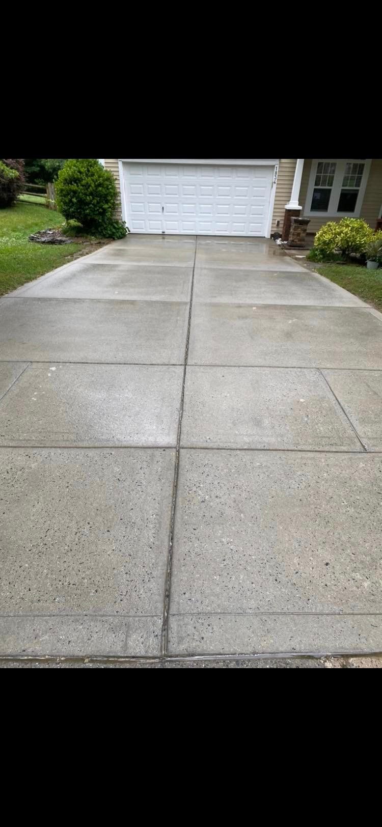 Bright, restored driveway following expert concrete cleaning services