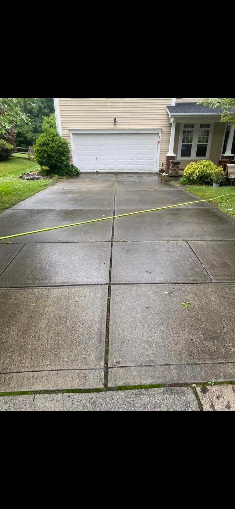 Dirty, moss-covered driveway before concrete cleaning and sealing services