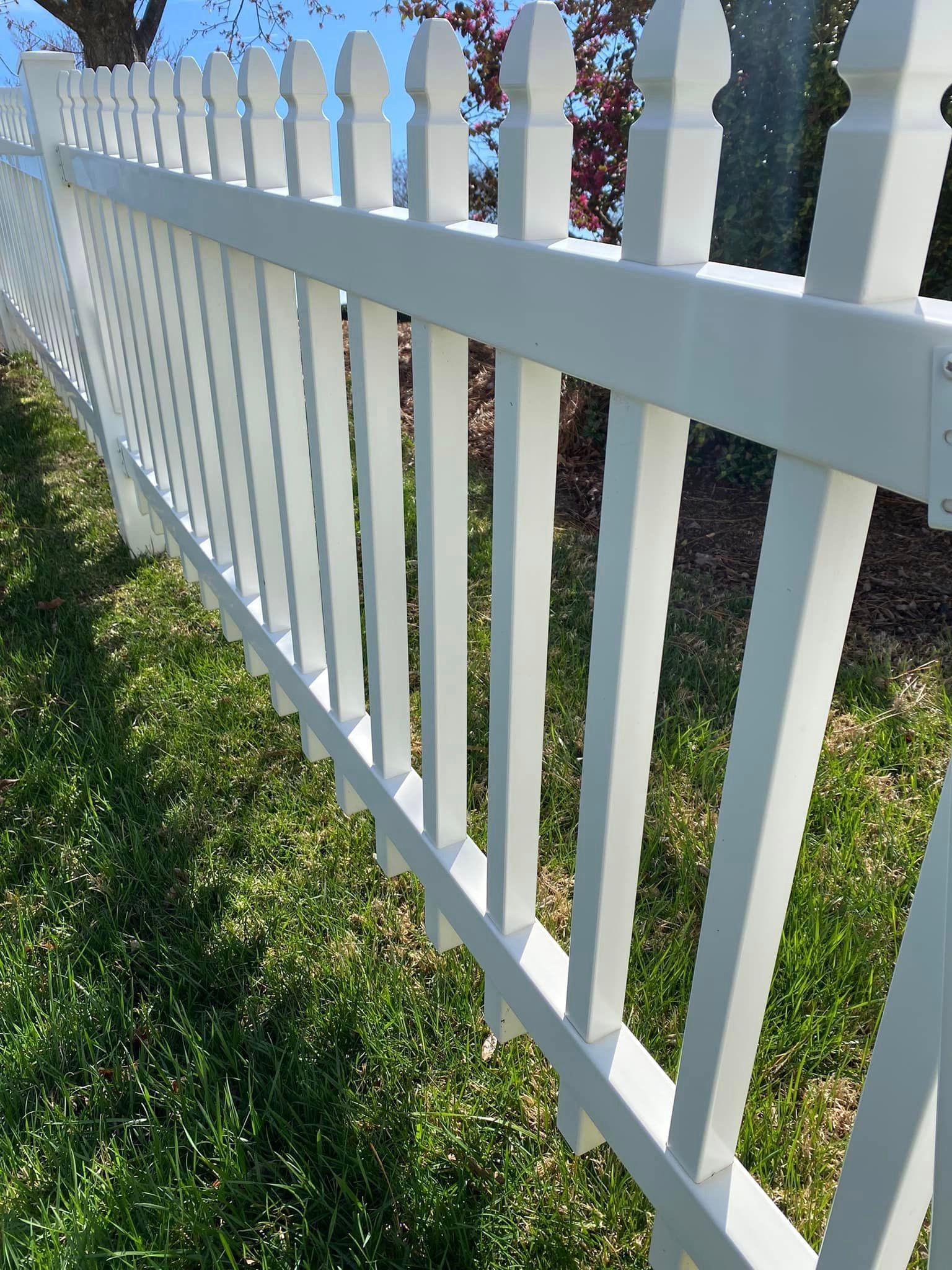 Bright white vinyl fence after thorough fence cleaning services