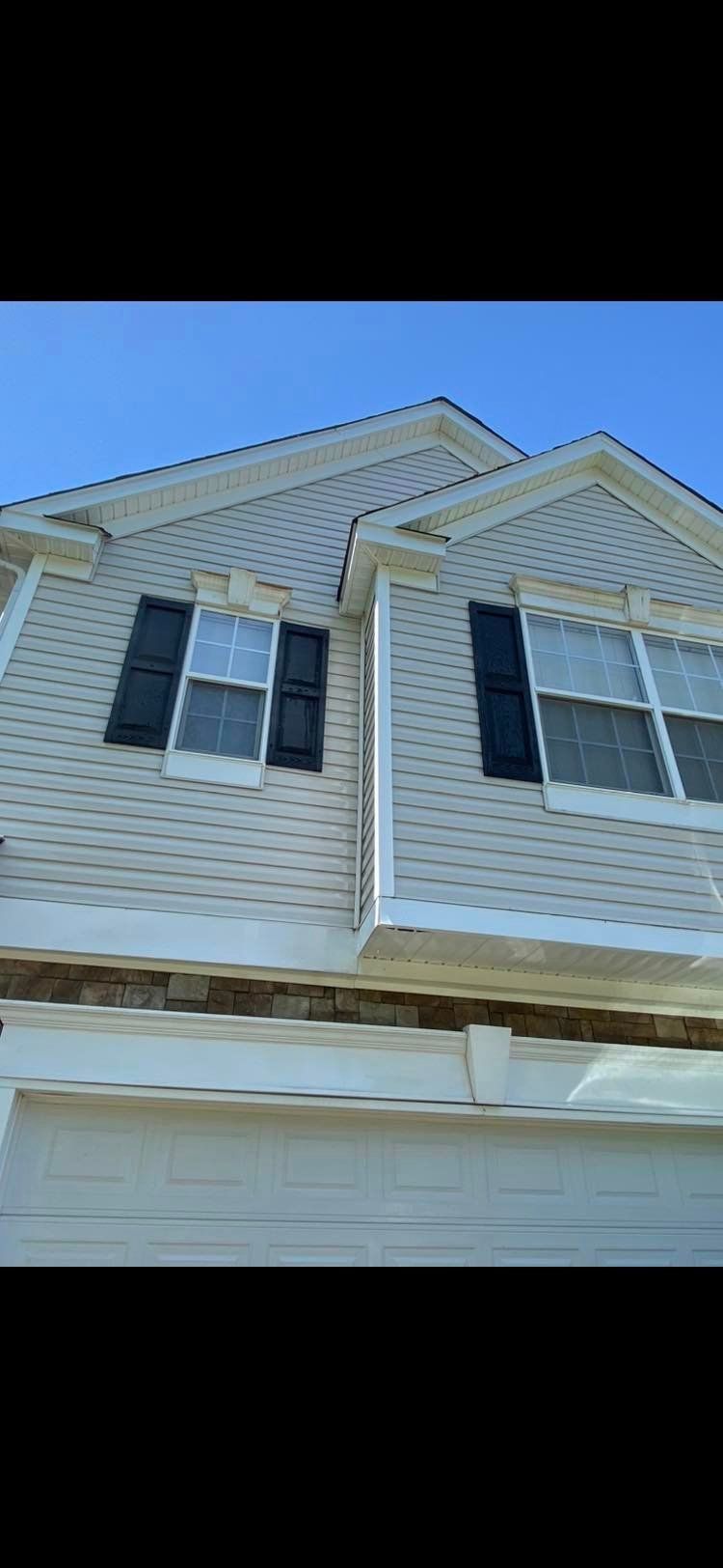 Clear and well-maintained siding after professional roof gutter cleaning