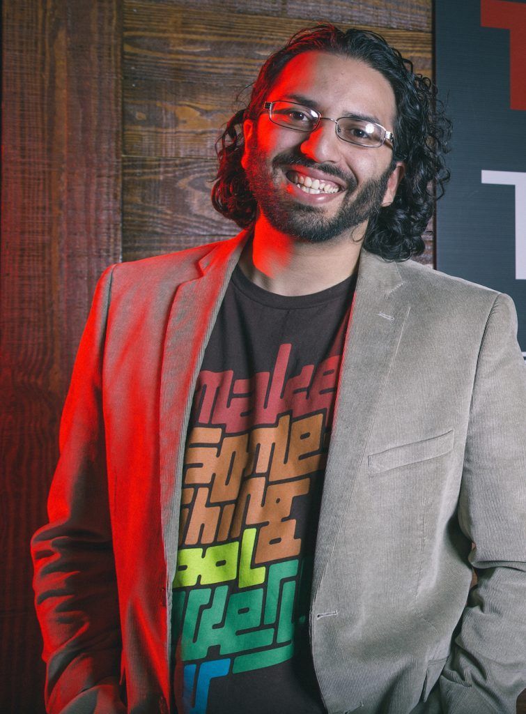 A man wearing glasses and a t-shirt that says 'make something cool everyday' on it