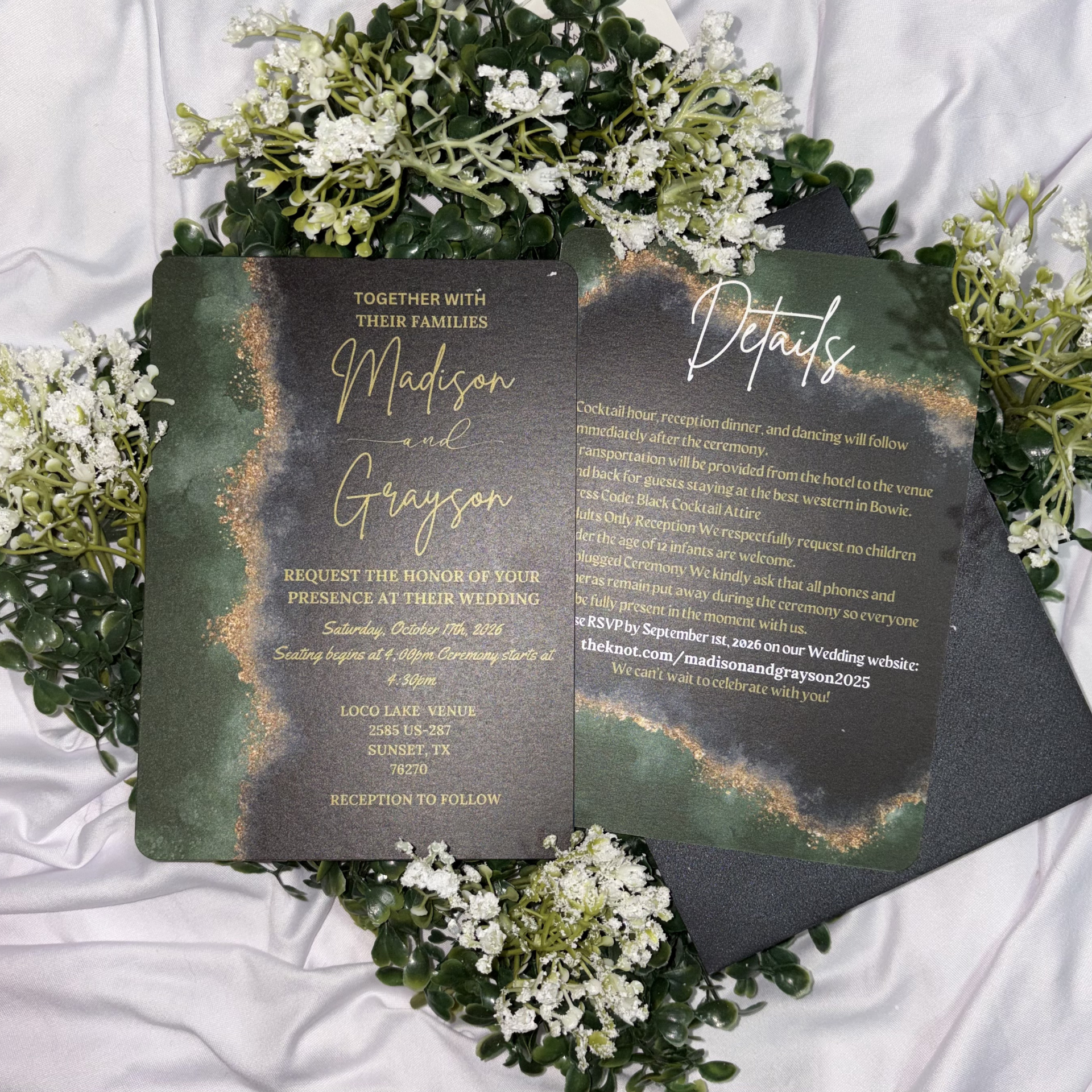 Dark floral wedding invitation suite with white flowers on a textured white cloth