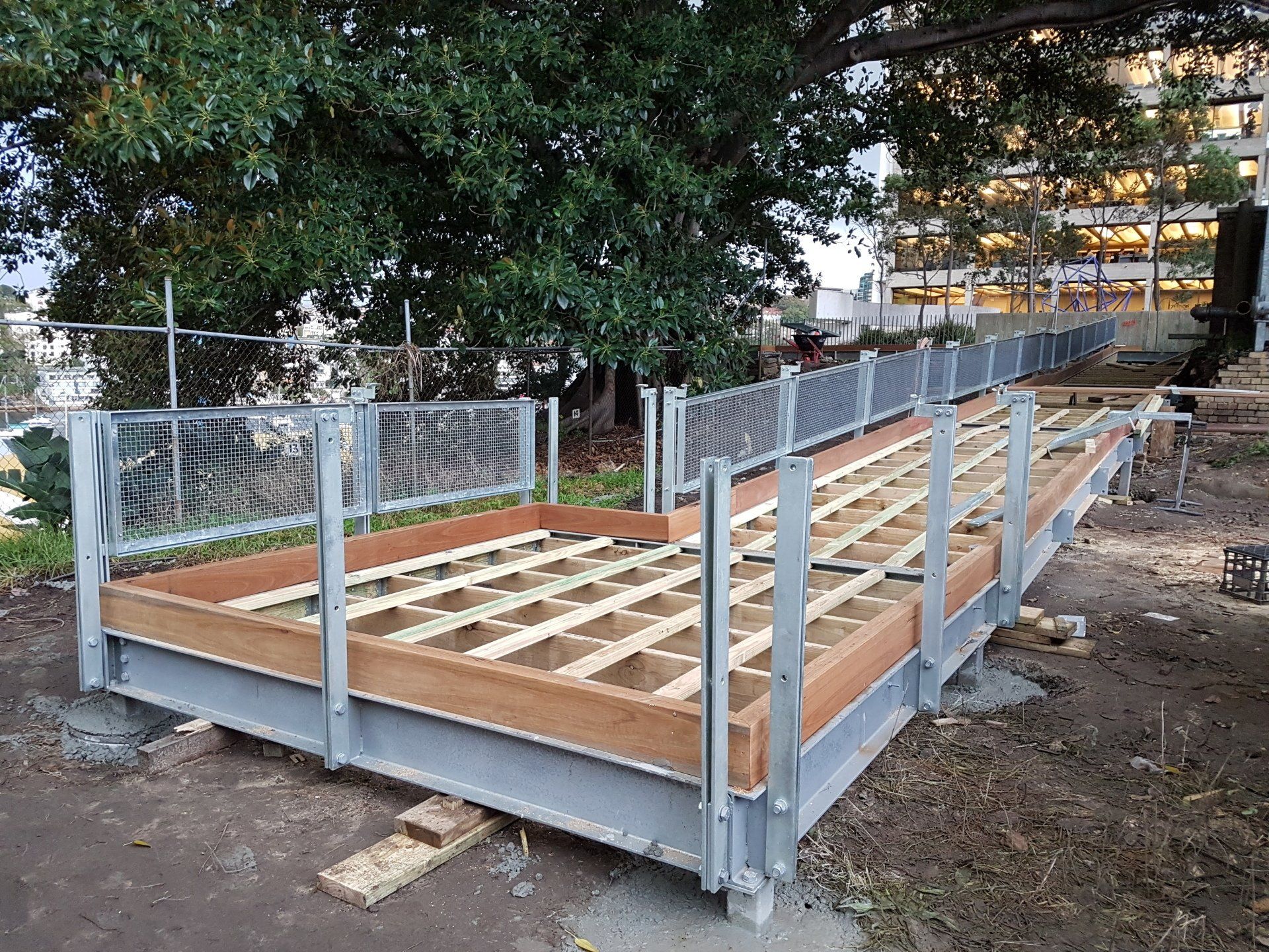 A wooden deck is being built on top of a metal structure.