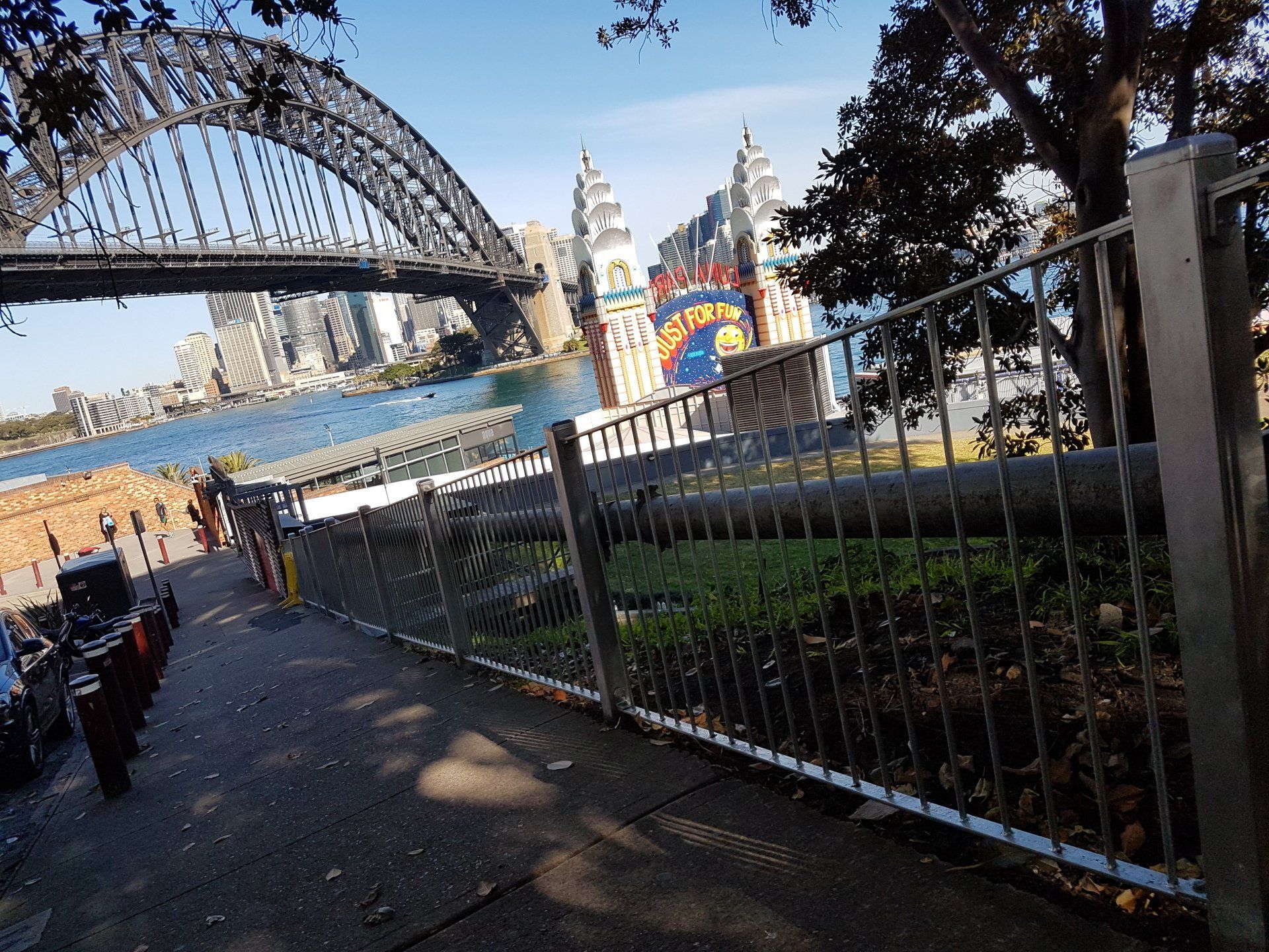A bridge over a body of water with a fence in the foreground