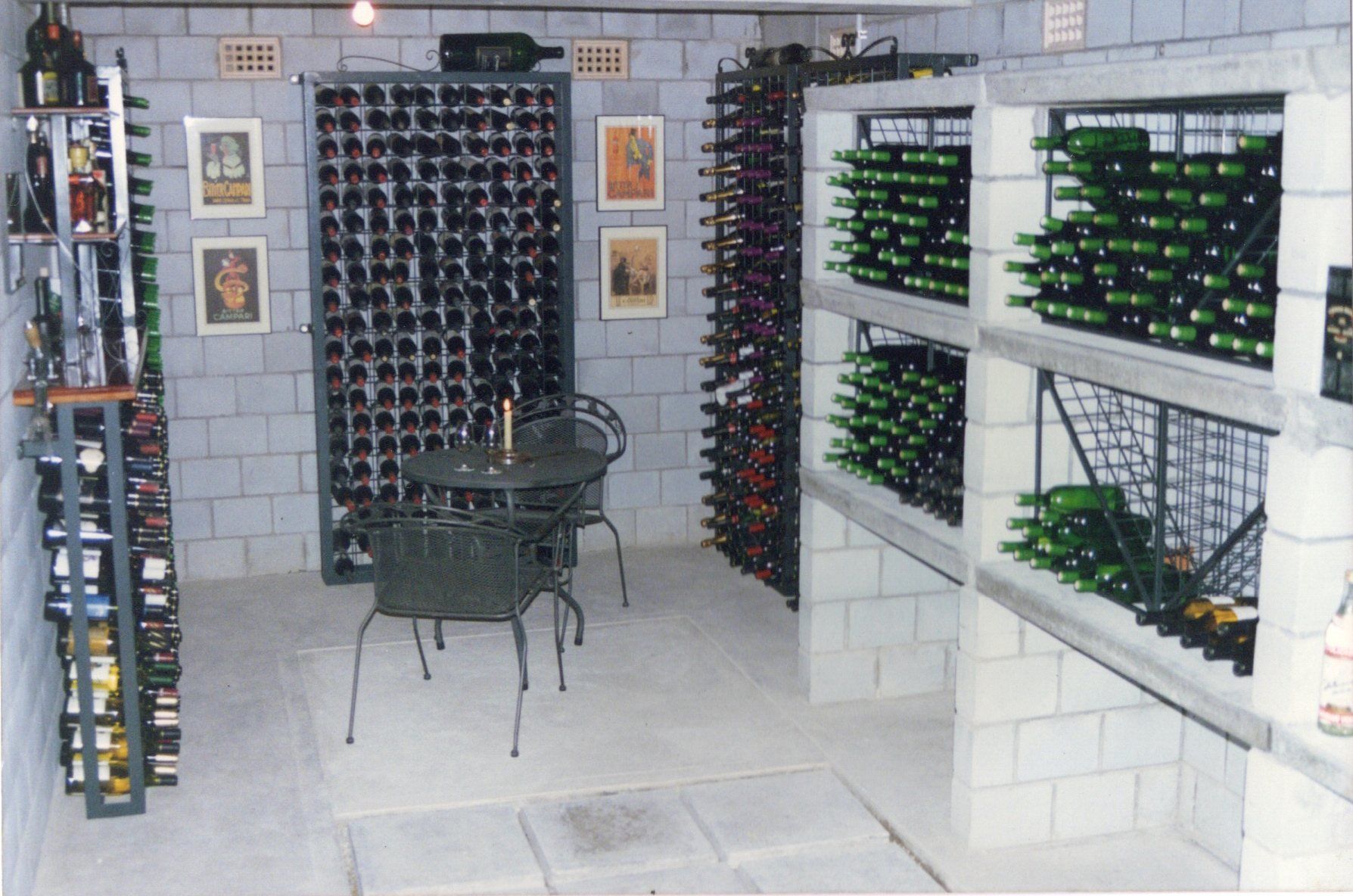 A wine cellar with lots of bottles and a table and chairs
