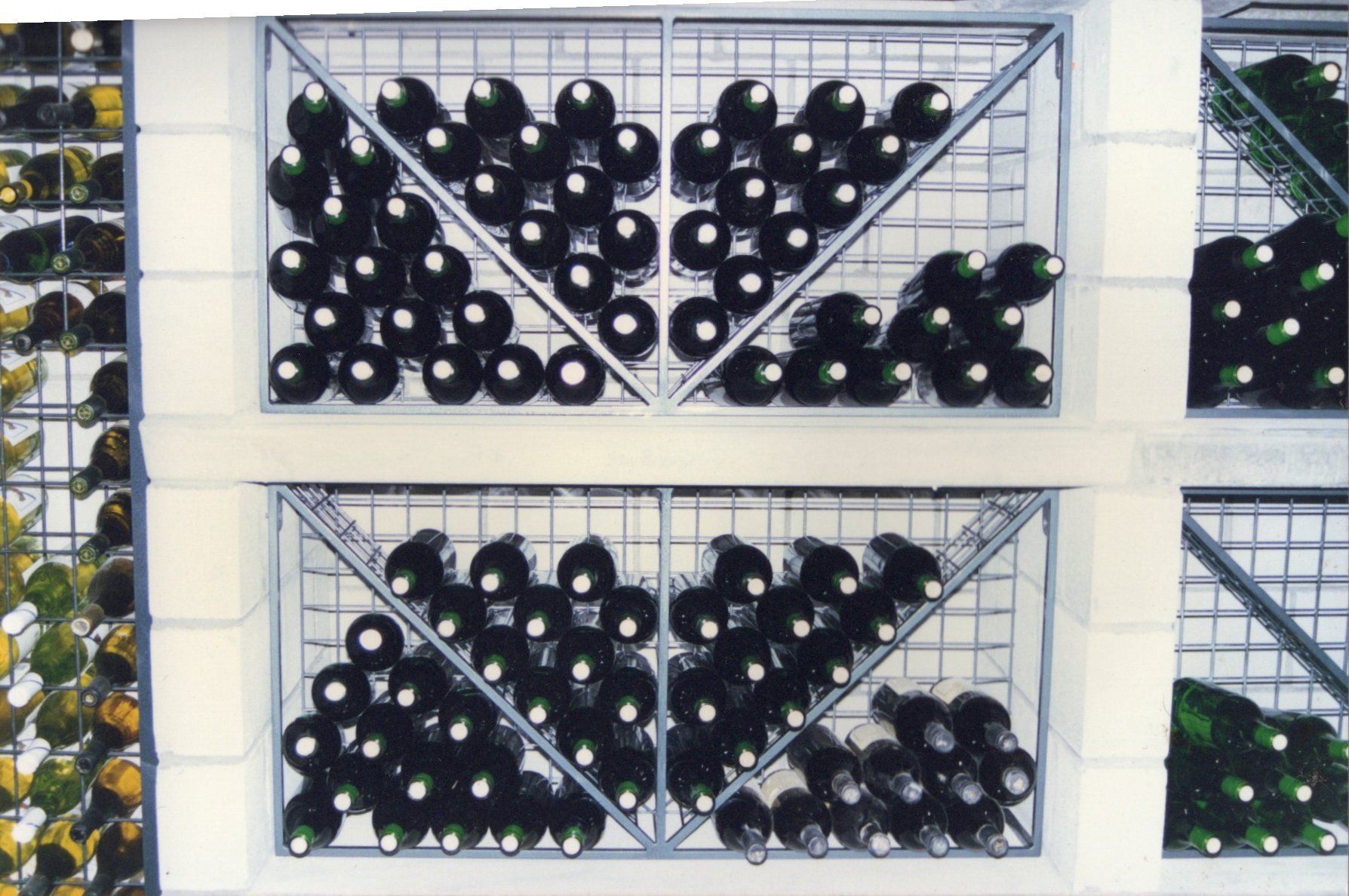 A bunch of wine bottles stacked on top of each other
