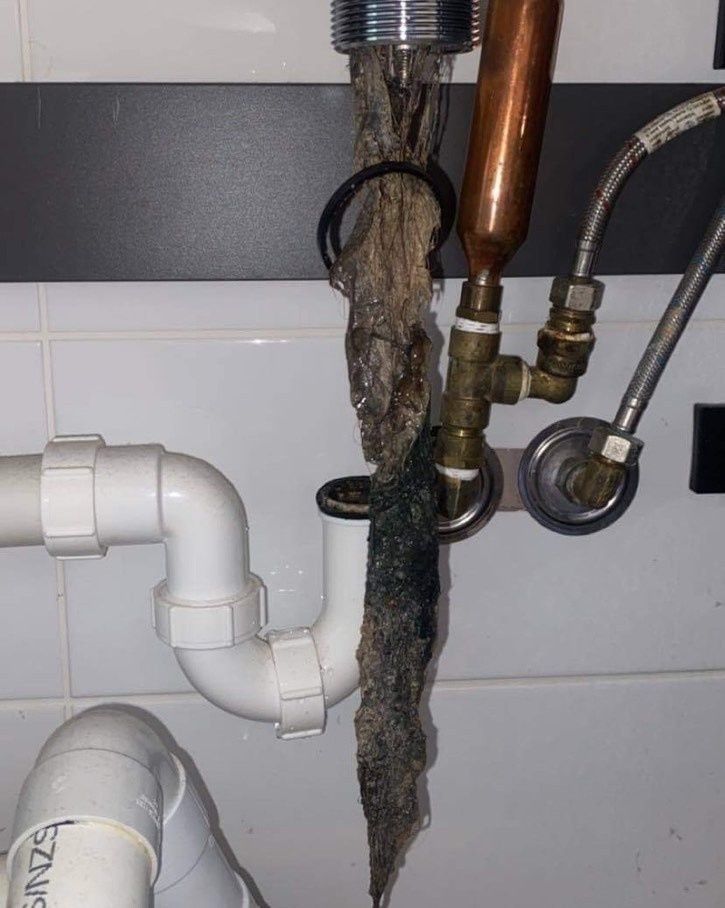 A Bathroom Sink with A Copper Pipe Coming out Of It — Aqua Blue Plumbing Services in Coffs Harbour, NSW 