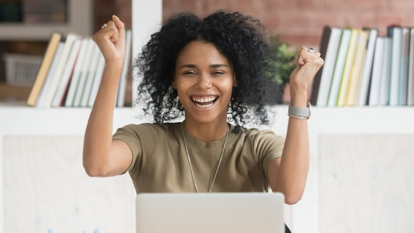 Happy student in front of her laptop