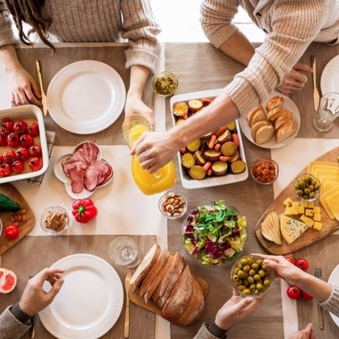 A group of people are sitting at a table eating food