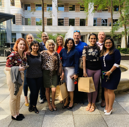 A group of people posing for a picture in front of a building