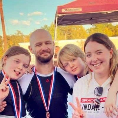 A group of people posing for a picture with medals around their necks