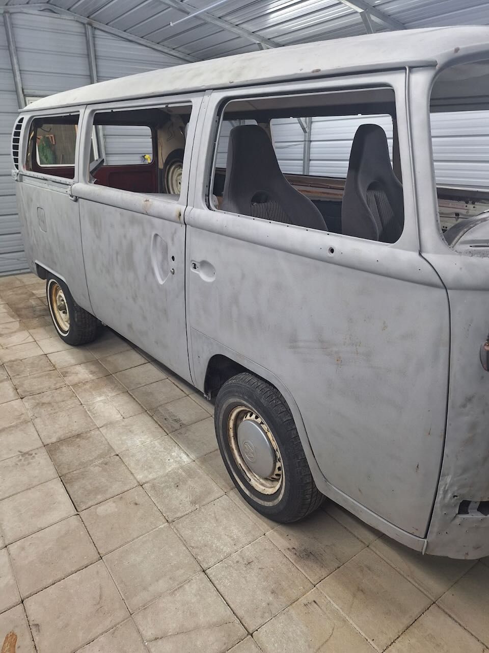 A white van is parked in a garage.